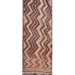 An early 20th century Kelin rug, woven with stepped zig-zag motifs within a serrated guard,