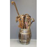 An early 20th century coopered oak barrel stick stand, containing a good selection of silver mounted