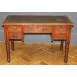 An Edwardian mahogany and beech writing desk, the rectangular top over single long and four short