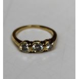 An 18ct gold diamond triology ring, featuring a total estimated 0.85ct of diamond across three round