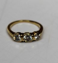 An 18ct gold diamond triology ring, featuring a total estimated 0.85ct of diamond across three round