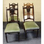 An early 19th century mahogany gateleg dining table, with demi lune drop leaves, on turned legs