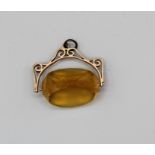 An unmarked yellow metal faceted glass fob spinner, gross weight approx 12.4gm