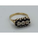 A 9ct gold sapphire and diamond East to West cluster ring. Gross weight approx 2.5gm, size N
