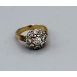 A diamond target ring featuring a central round brilliant cut diamond estimated 0.40ct plus eight