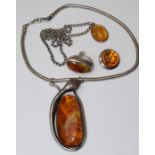 A selection of Baltic amber jewellery comprising a large serpent snake pendant, featuring a large