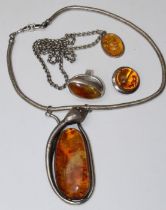 A selection of Baltic amber jewellery comprising a large serpent snake pendant, featuring a large