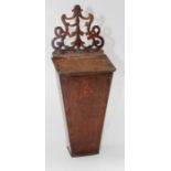 A George III oak candle box with fret carved surmount over leather hinged rising cover and