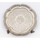 An early Victorian silver card tray, shaped circular with ribbon tied reeded border, the body