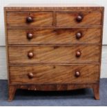 An early 19th century mahogany chest of two short and three graduated long drawers with knop