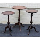 Three reproduction mahogany wine tables, each with circular top, on three splayed legs. The
