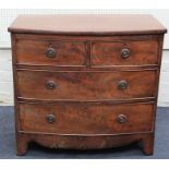 A 19th century mahogany bow front chest of two short and two long drawers with brass ring handles,