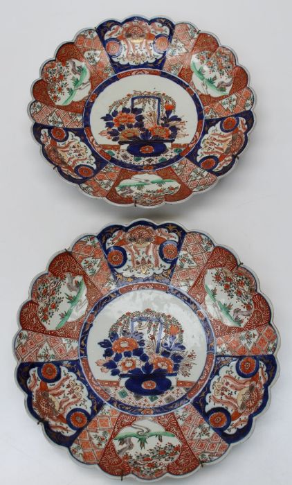 A pair of large, late 19th century Japanese Imari scallop edged dished chargers. Each centrally