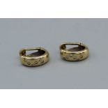 A pair of 14ct gold, diamond set chunky half hoop earrings with clip backs. An estimated twelve