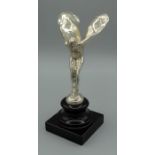 A silver figure of The spirit of Ecstacy after Charles Sykes, raised on a socle and plinth base,