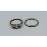 A yellow metal dress ring set with aquamarine and split pearls, claw set in white metal, size S,