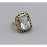 An Aquamarine cocktail ring in a decorative yellow metal setting stamped 585, size M, gross weight