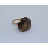 A large smoky Quartz cocktail ring, size R, in 9ct gold, gross weight 8.7gm