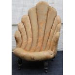 An Edwardian scallop form nursing chair on turned tapering legs and castors