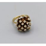 A diamond bombe ring in yellow metal, shank stamped 18ct. Gross weight 9.8gm, size M, estimated