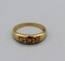A Gypsy set three diamond ring with three old mine cut diamonds (est 7-10 points each), size I,