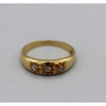 A Gypsy set three diamond ring with three old mine cut diamonds (est 7-10 points each), size I,