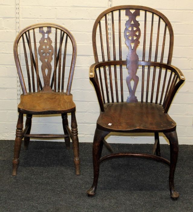 A late 19th century wheel and stick back armchair and three standard wheel back dining chairs (4)