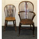 A late 19th century wheel and stick back armchair and three standard wheel back dining chairs (4)