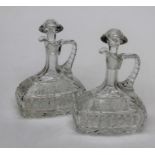 A pair of early 20th century moulded glass claret jugs, each with mushroom stopper, 26cm high