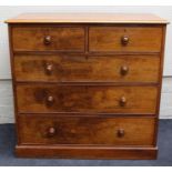 An early 19th century walnut chest of two short and three graduated long drawers with knop