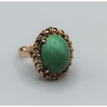 A sugar loaf cut turquoise pebble ring in pinkish yellow metal, stamped 14c. Gross weight approx 6gm