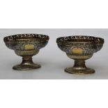 A pair of gilded silver table bowls, of a quatrefoil form on oval foot, with pierced rim and