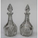 A pair of Victorian cut lead crystal mallet form decanters, each with flame stopper, 33cm high