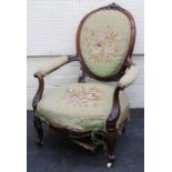 A Victorian walnut framed lady's spoon back open armchair with gros point woolwork upholstery