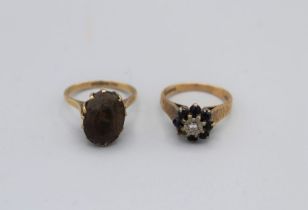 A pair of 9ct gold rings. One a sapphire and diamond cluster with textured band, size L (missing