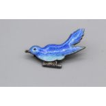 An enamelled white metal brooch in the form of a bluebird. The enamel is in good condition with