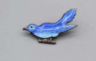 An enamelled white metal brooch in the form of a bluebird. The enamel is in good condition with
