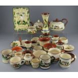 A large group of Torquay motto ware including bowls, plates, jugs etc. In good overall condition,