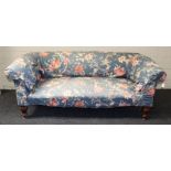 A Victorian mahogany framed two person settee with later Japonoise upholstery, on turned forelegs,