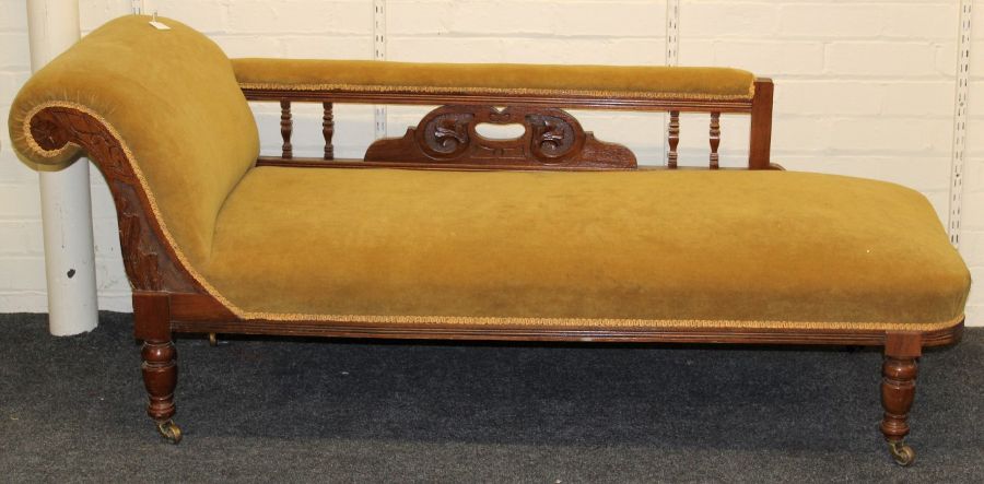 A late Victorian walnut framed scroll end chaise longue with moss/mustard plush upholstery, on