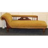 A late Victorian walnut framed scroll end chaise longue with moss/mustard plush upholstery, on