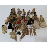 A collection of several dozen largely Edwardian bisque dolls, most in period costume. The largest