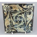 A Martin Brothers stoneware floor tile decorated in buff tones in a geometric form. 15 cm wide.