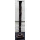 A 19th century mahogany torchere with wrythen and stiff leaf carved column, on stepped square