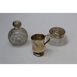 Two silver mounted cut glass dressing table bottles/jars and a silver Christening mug. Various dates