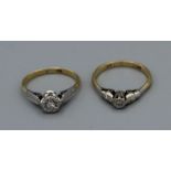 A pair of Art Deco Era diamond solitaire rings. Both stamped 18ct and Plat. One size M the other