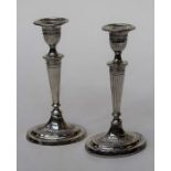 Elkington and Co ltd, a pair of George V silver table candlesticks of Neo Classical form, with
