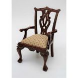 A reproduction imported hardwood George II style doll's/bear's carver chair, with drop in seat.