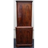 A reproduction mahogany floorstanding corner cupboard, the dentil cornice over two pairs of oval