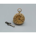 A ladies yellow metal pocket watch (untested), case stamped 18k with ornate yellow metal dial with